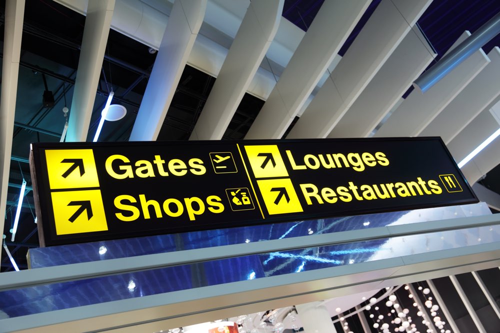 Airport flight gate, shop, restaurant and lounge direction information sign
