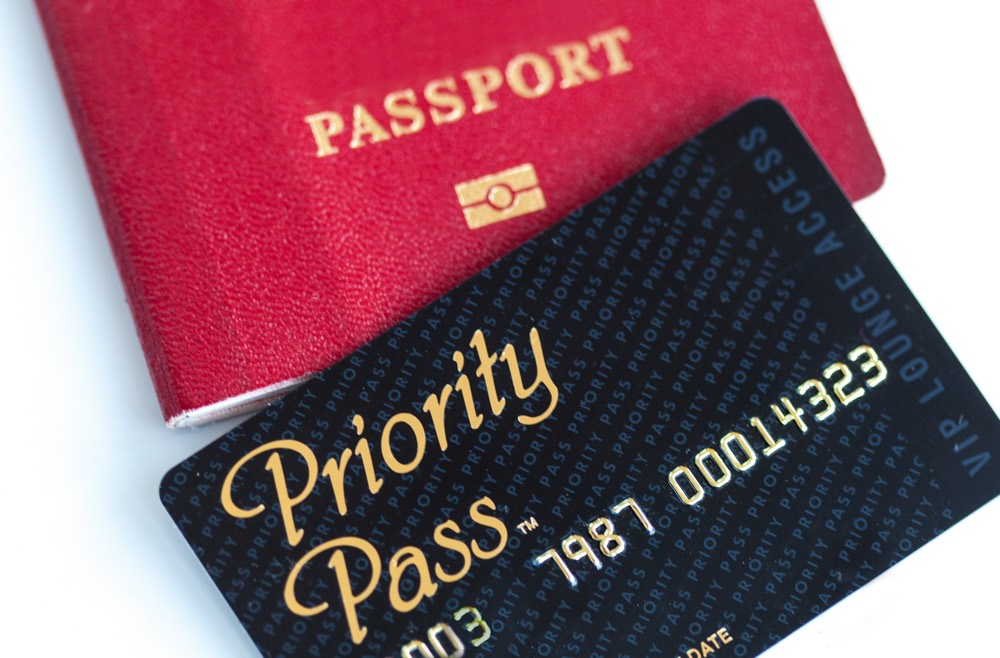 Priority Pass for VIP lounge access and international passport. Travel concept. White background