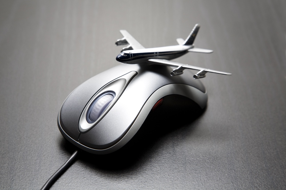 Toy airplane placed on a computer mouse
